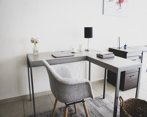 A clean workspace environment with a ceramic mug and organized paper notebook